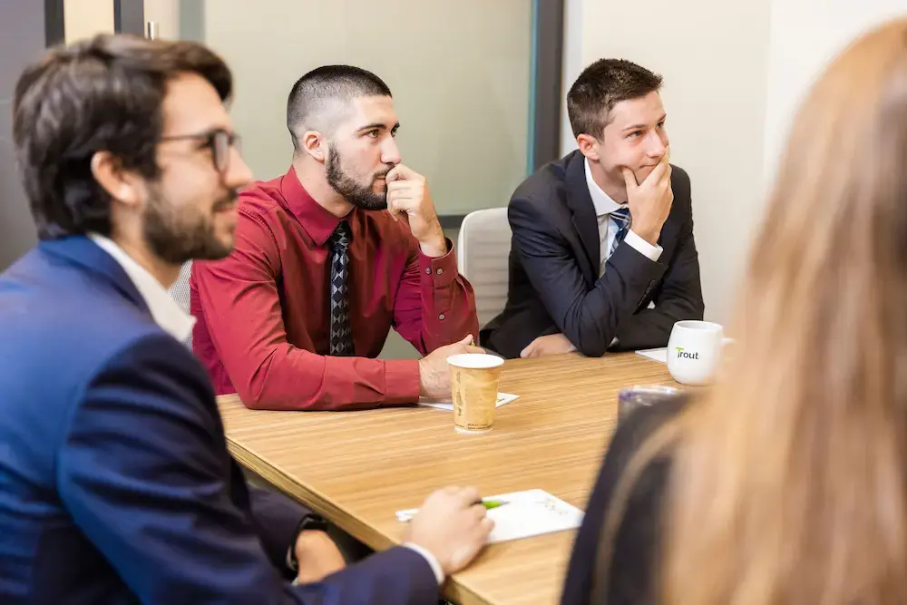 accounting interns sitting at conference table